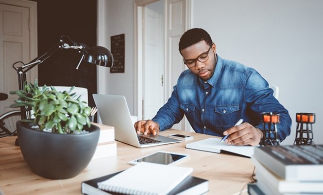 Afro american young man working at home office